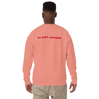 Person wearing a rose pink sweatshirt with red text on the back against a white background