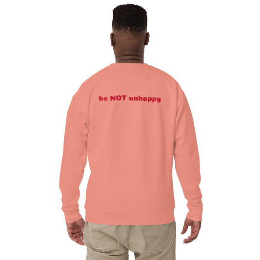 Person wearing a rose pink sweatshirt with red text on the back against a white background