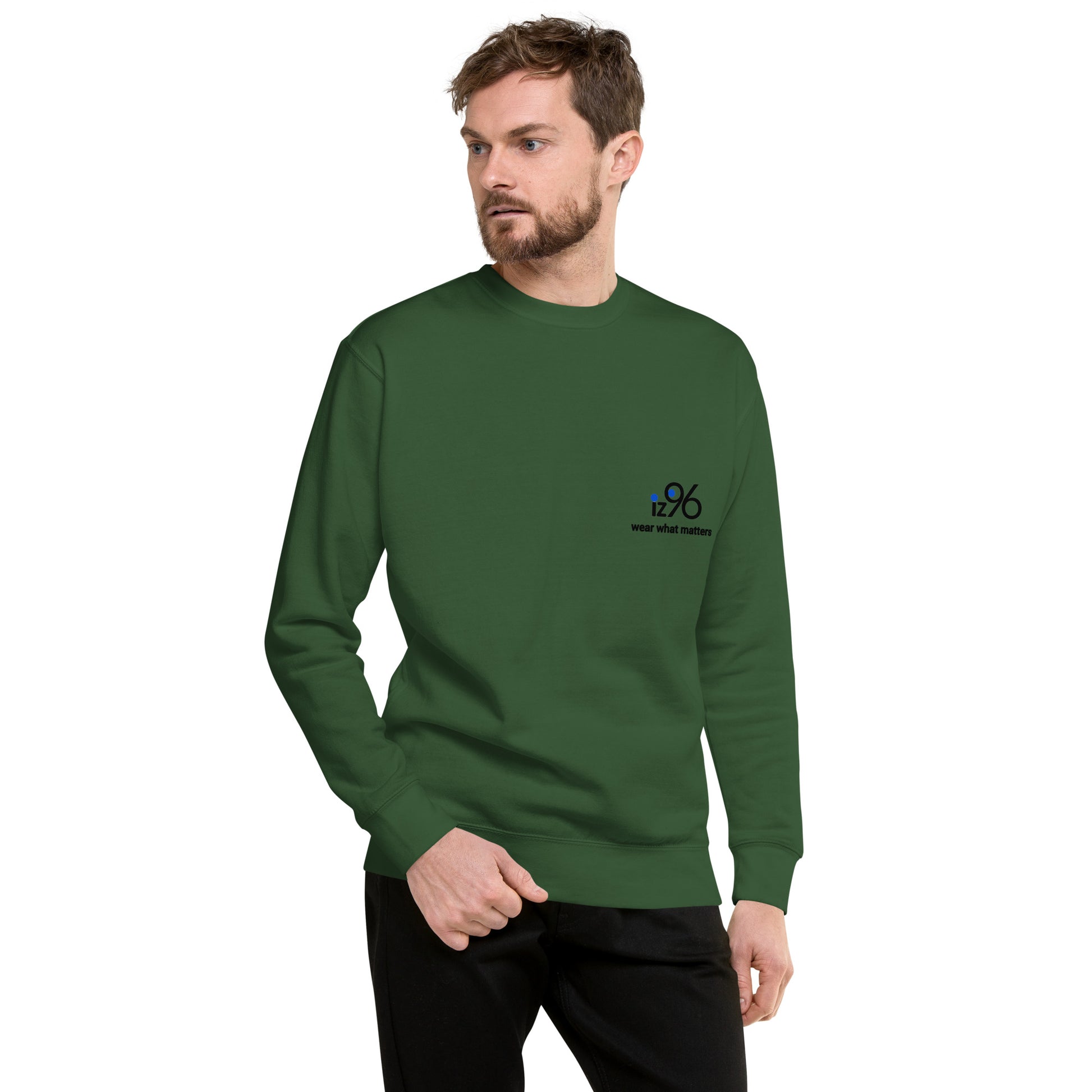 Man wearing a forest green sweater on a white background