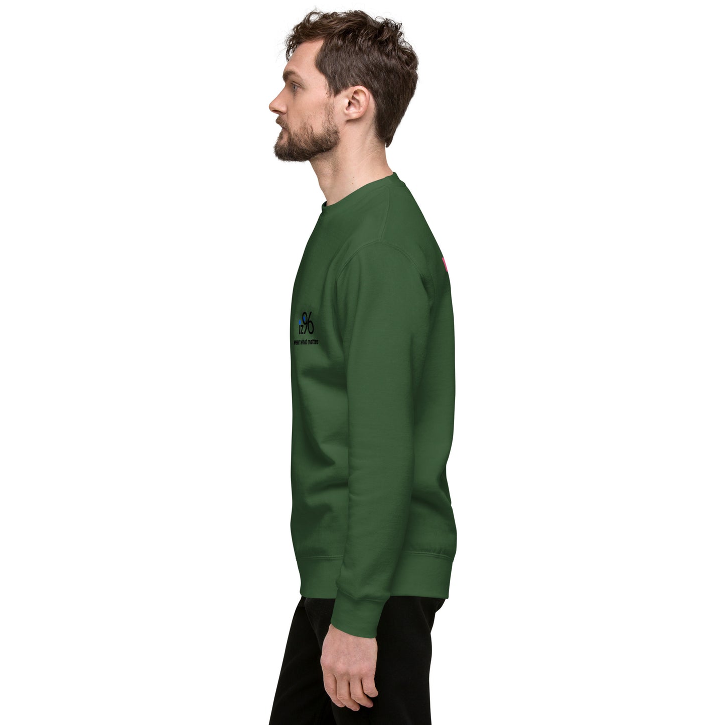 Man wearing a green sweatshirt with a logo against a white background