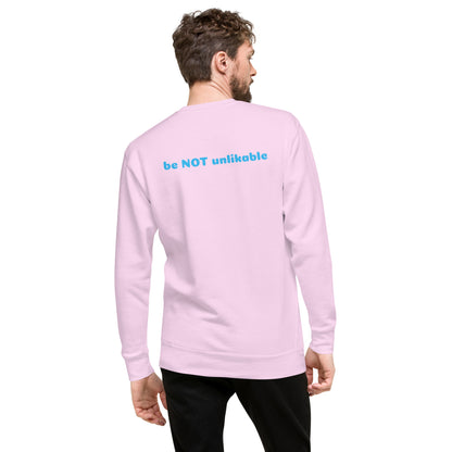 Person wearing a lavender long-sleeve shirt with text on the back, standing against a white background