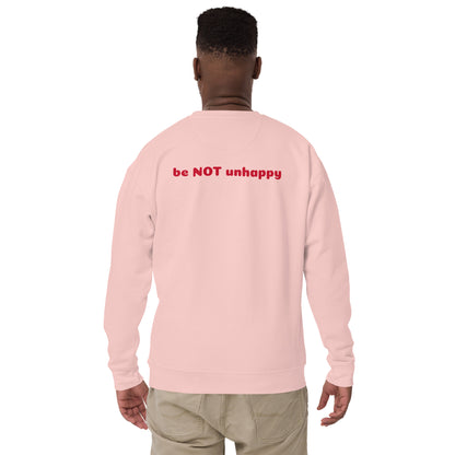 Person wearing light pink sweatshirt with 'be NOT unhappy' text on the back, standing against a white background.