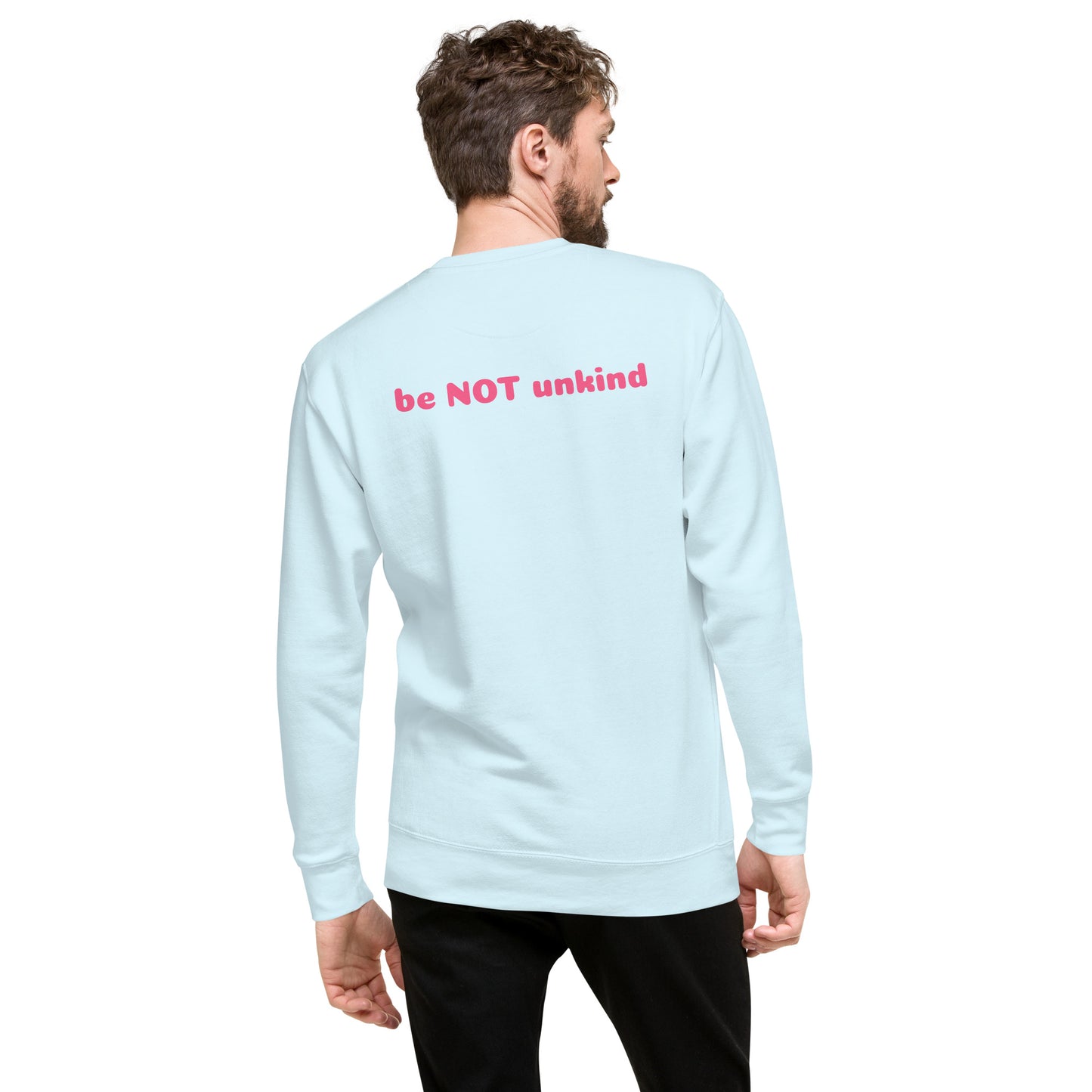Man wearing a sky blue long-sleeve shirt with 'be NOT unkind' text on the back, standing against a white background.