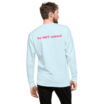 Man wearing a sky blue long-sleeve shirt with 'be NOT unkind' text on the back, standing against a white background.