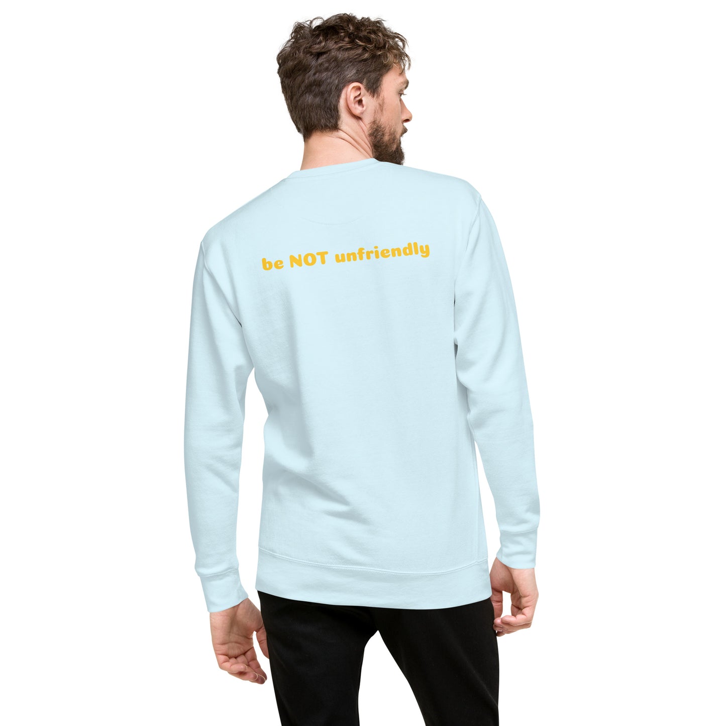 Man wearing a light blue long-sleeve shirt with 'be NOT unfriendly' text on the back, standing against a white background.