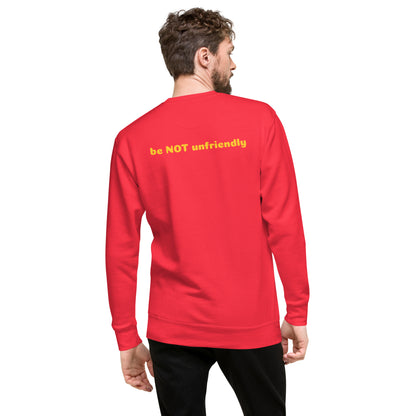 Person wearing a red sweatshirt with yellow text on the back, standing against a white background