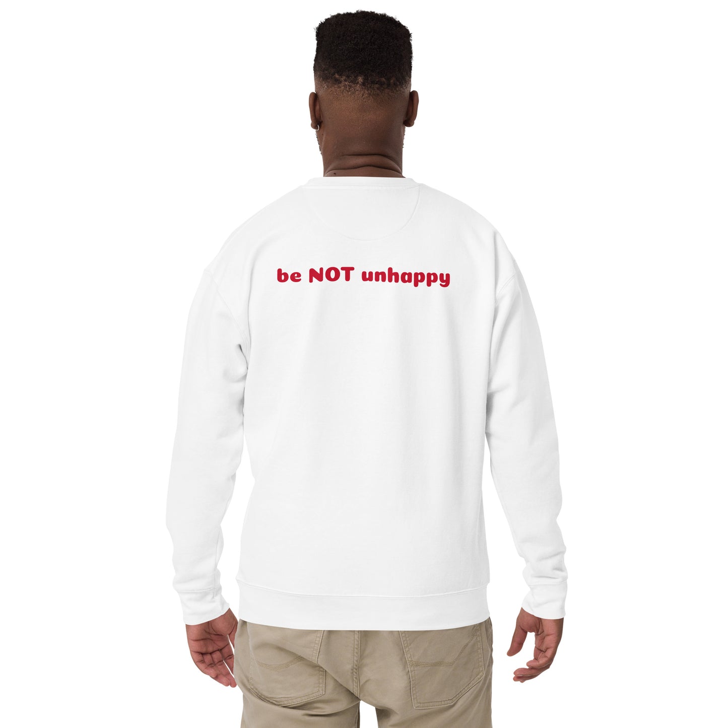 Person wearing a white long-sleeve shirt with 'be NOT unhappy' text on the back, standing against a white background.