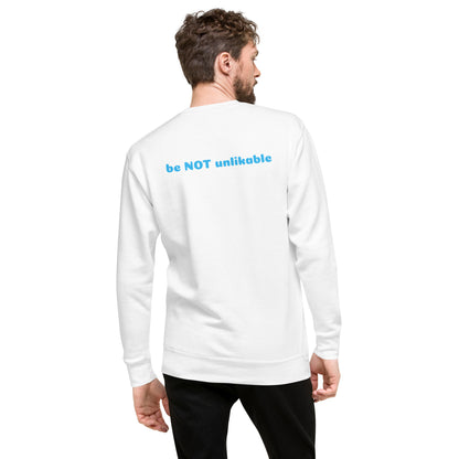 Man wearing a white long-sleeve shirt with 'be NOT unlikable' text on the back against a white background