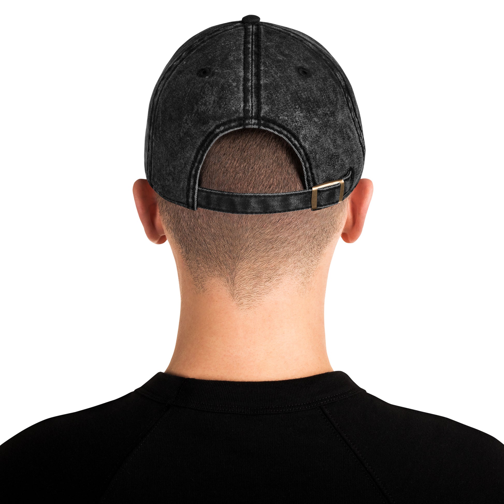 Person wearing a black denim cap from behind on a white background