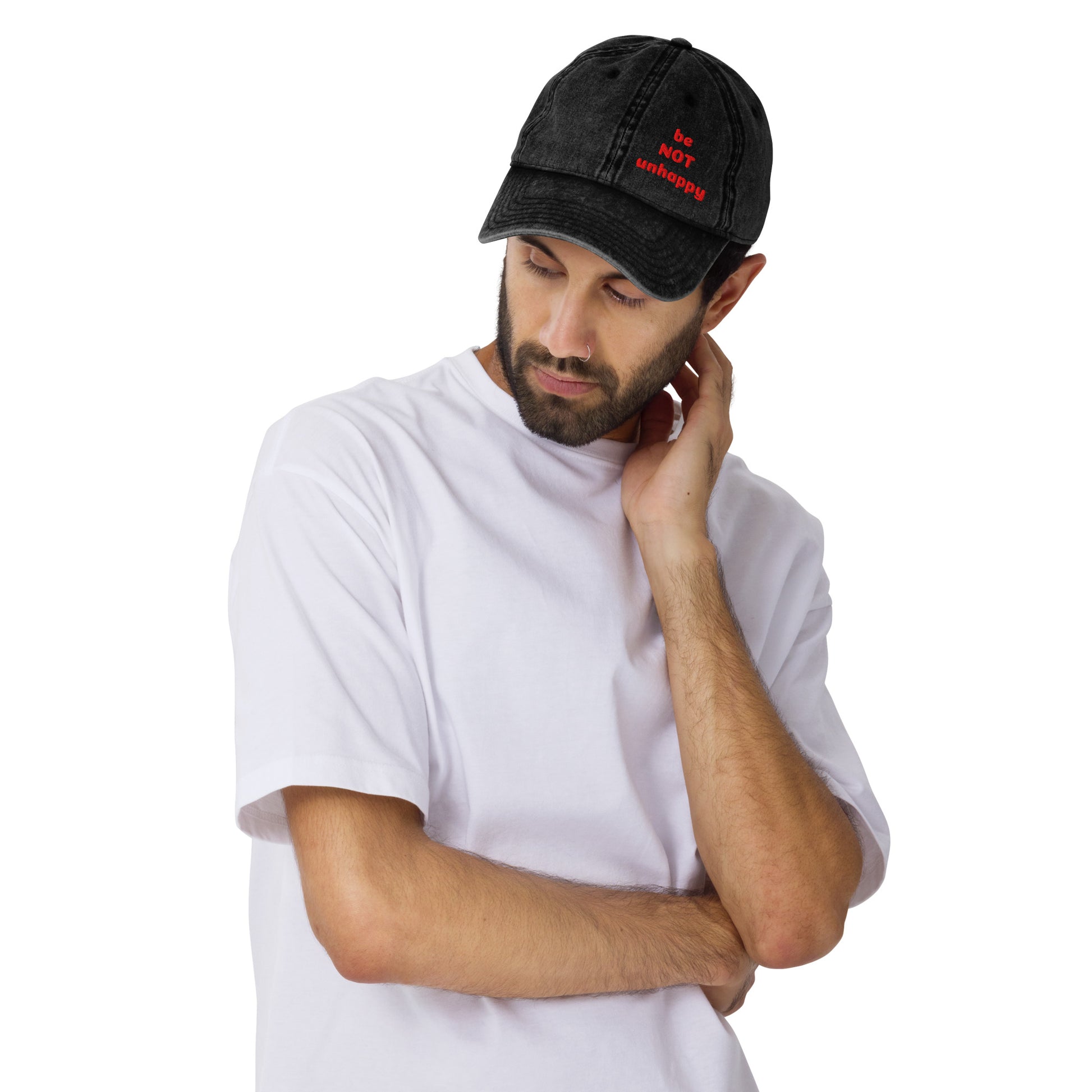 Man wearing a black cap and white t-shirt on a white background
