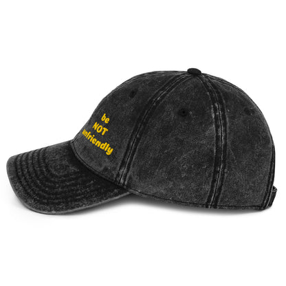 Black distressed baseball cap with yellow text on a white background