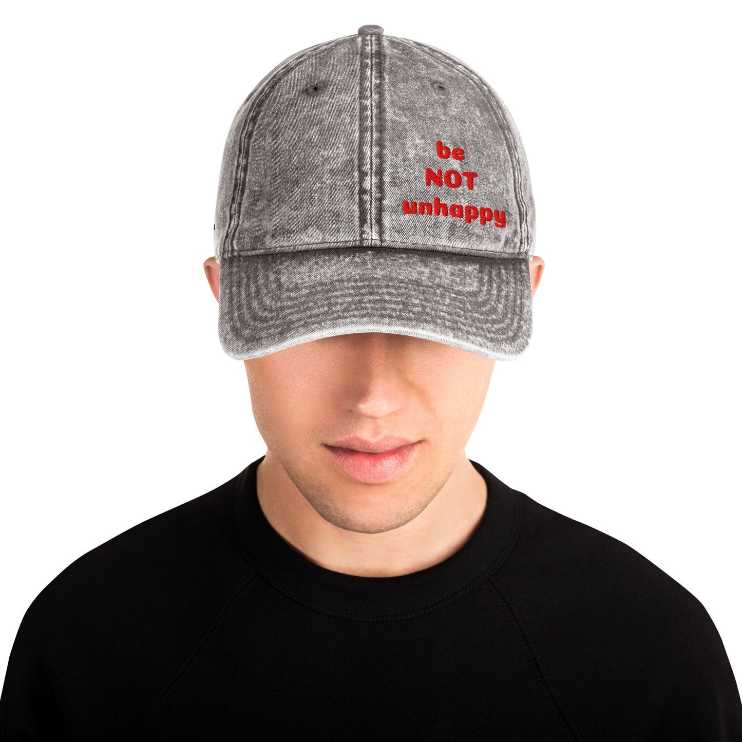 Person wearing a gray denim cap with red text on a white background
