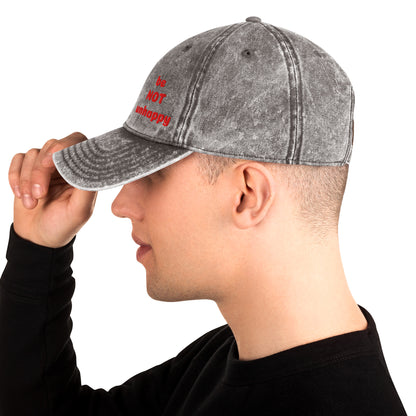 Person wearing a gray denim cap with red text on a white background