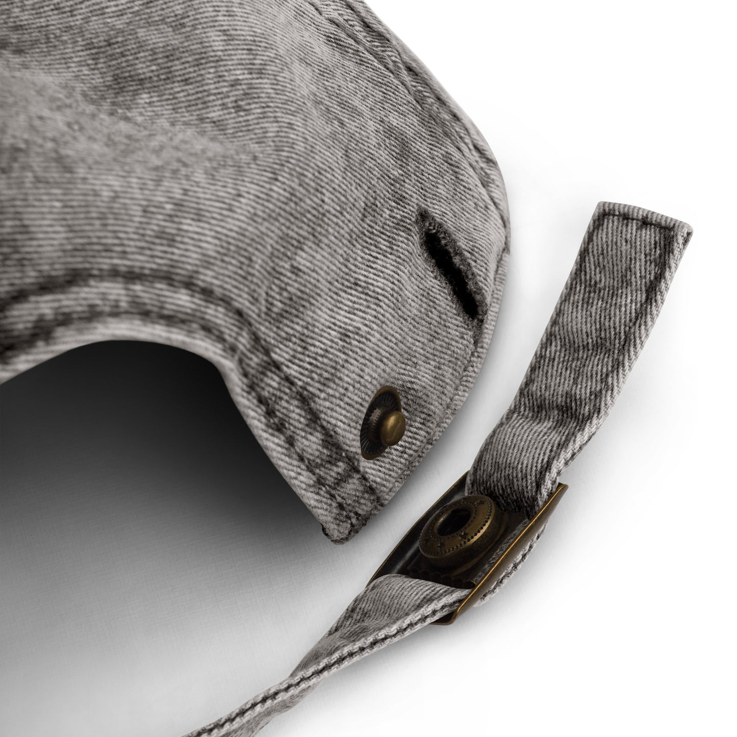Close-up of a gray fabric dog muzzle with brass buttons on a white background