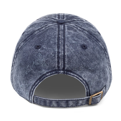 Blue denim cap with a brown strap on a white background