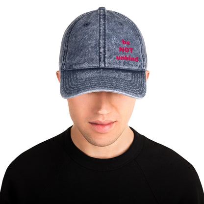 Person wearing a denim cap with 'be NOT unking' text on a white background
