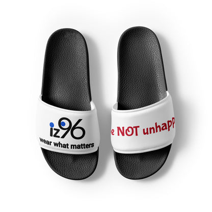 White slides with black soles featuring 'iz96' and 'wear what matters' on one and 'Not unhappy' on the other, on a white background.