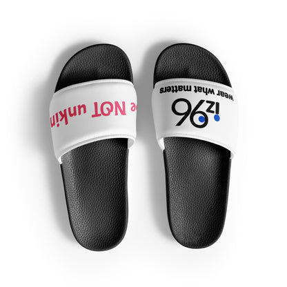 Black slide sandals with white straps featuring text on a white background
