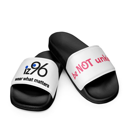 Black slides with white straps featuring text on a white background