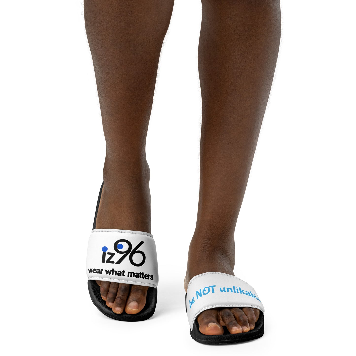 White sandals with a text and logo design worn by a person on a white background