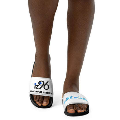 White sandals with a text and logo design worn by a person on a white background