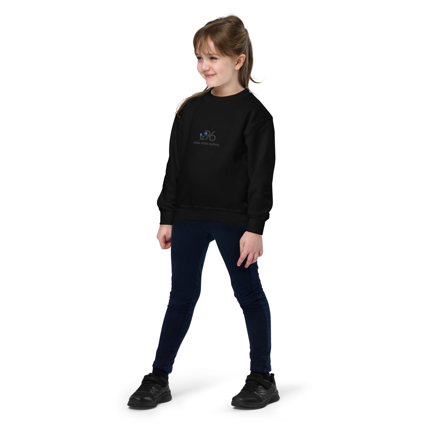 Young girl wearing a black sweatshirt with text on a white background