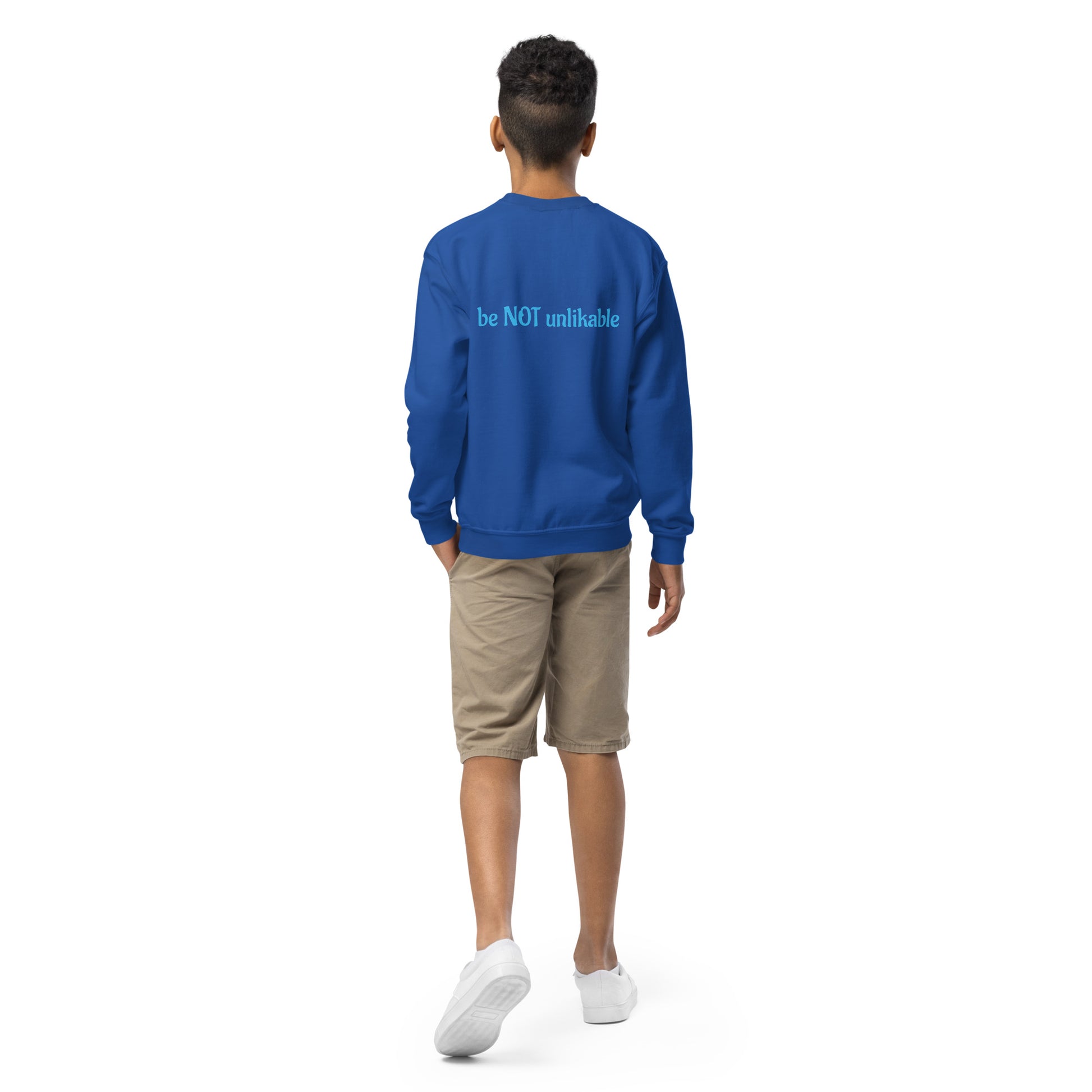 Person wearing a blue sweatshirt with a text on the back, standing against a white background