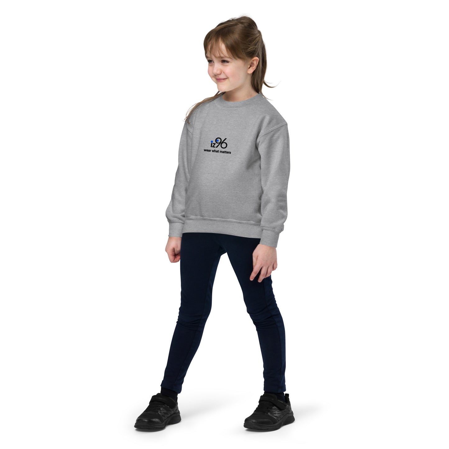 Young girl wearing a gray sweatshirt with a logo brand on a white background