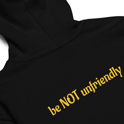 Black hoodie with yellow text 'be NOT unfriendly' on a white background