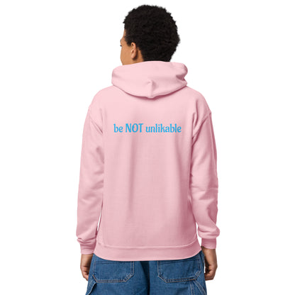 Person wearing a pink hoodie with 'be NOT unlikable' text on the back, standing against a white background.