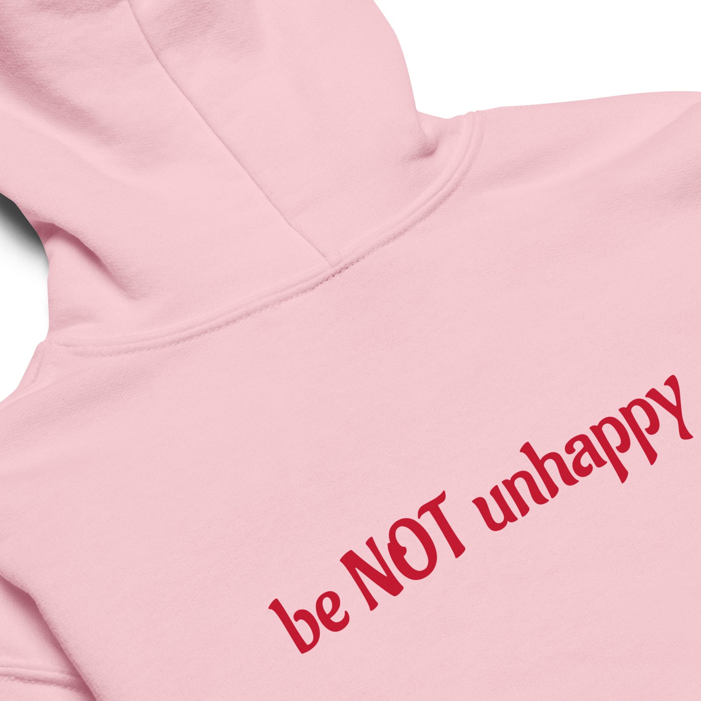 Pink hoodie with 'be NOT unhappy' text in red on a white background