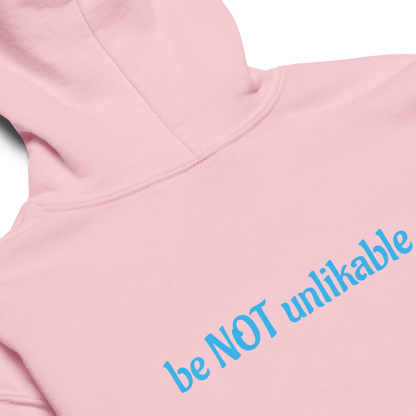 Pink hoodie with blue text 'be NOT unlikable' on a white background