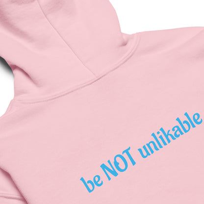 Pink hoodie with blue text 'be NOT unlikable' on a white background