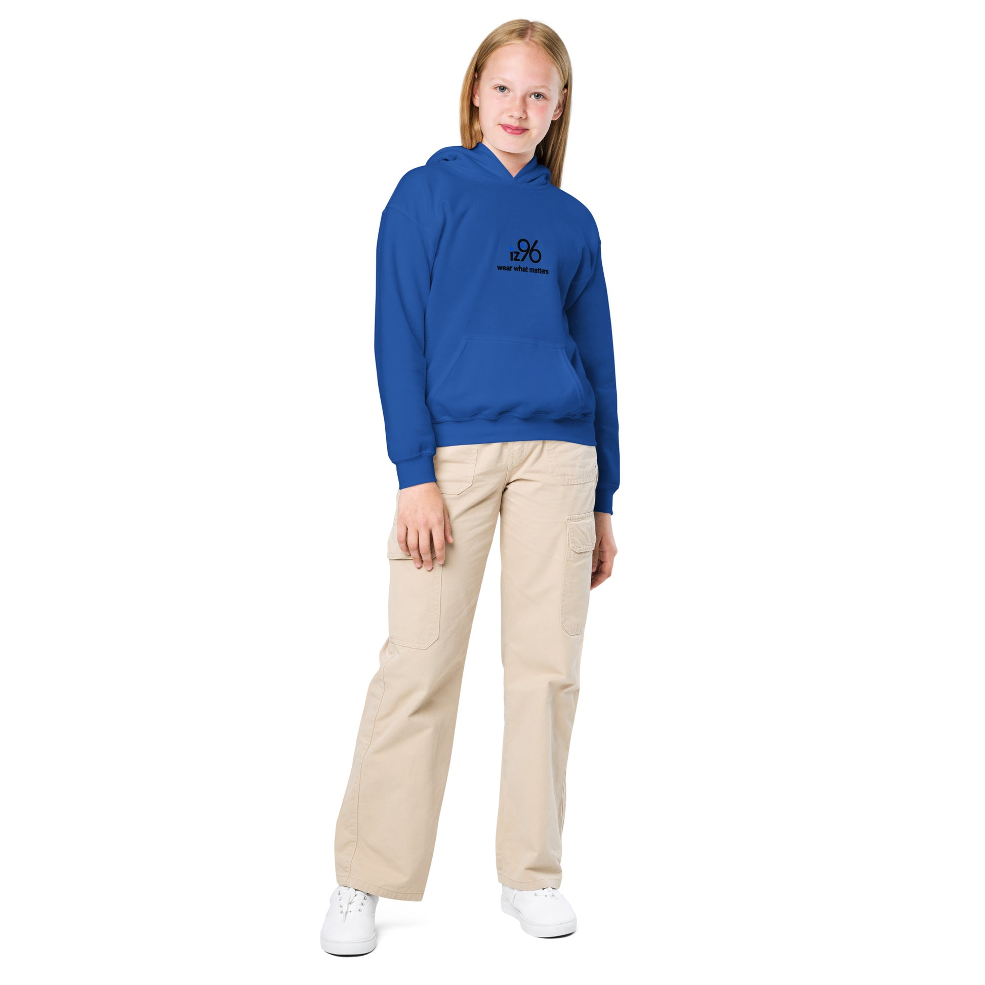 Person wearing a blue hoodie with text and beige pants on a white background
