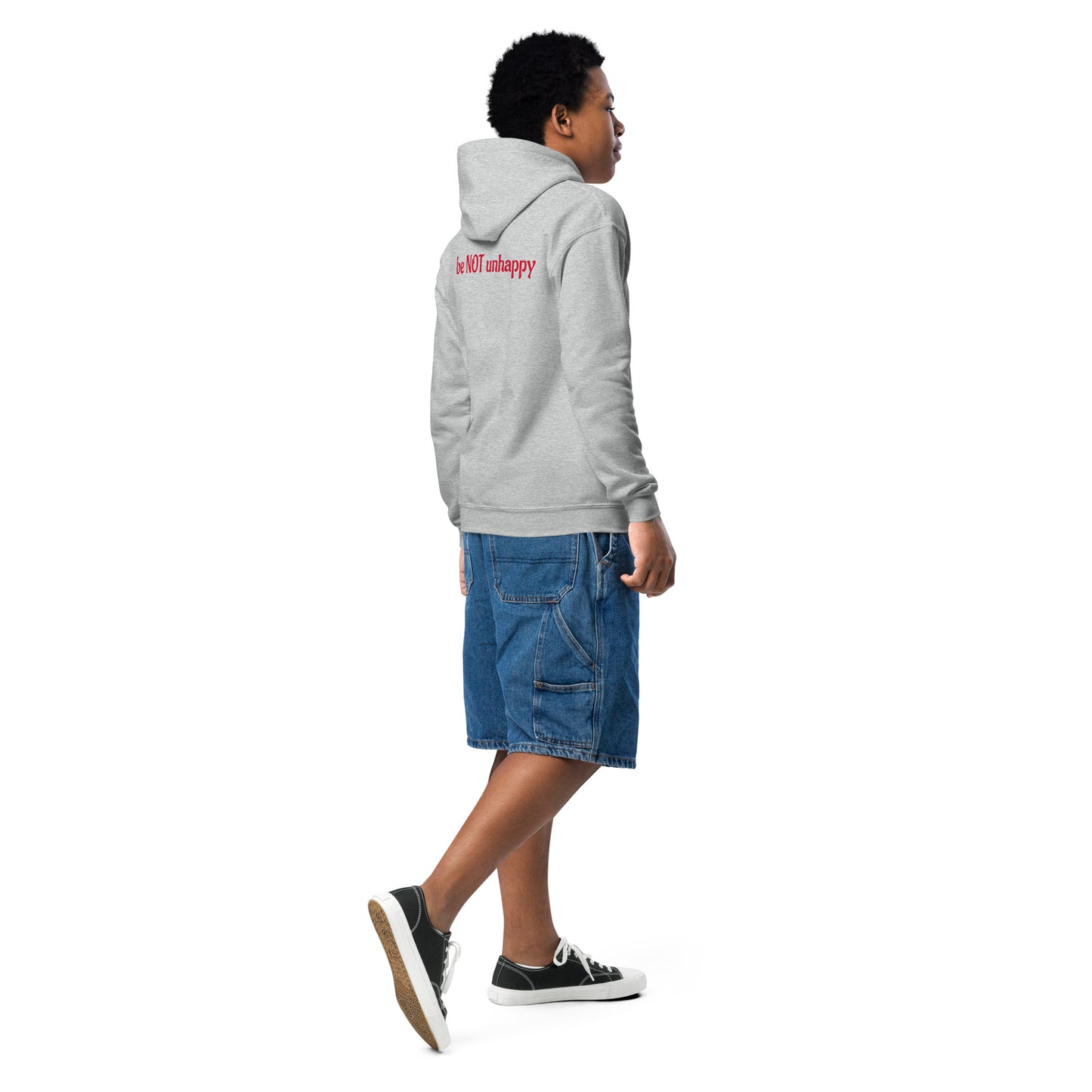 Person wearing a gray hoodie and blue shorts on a white background