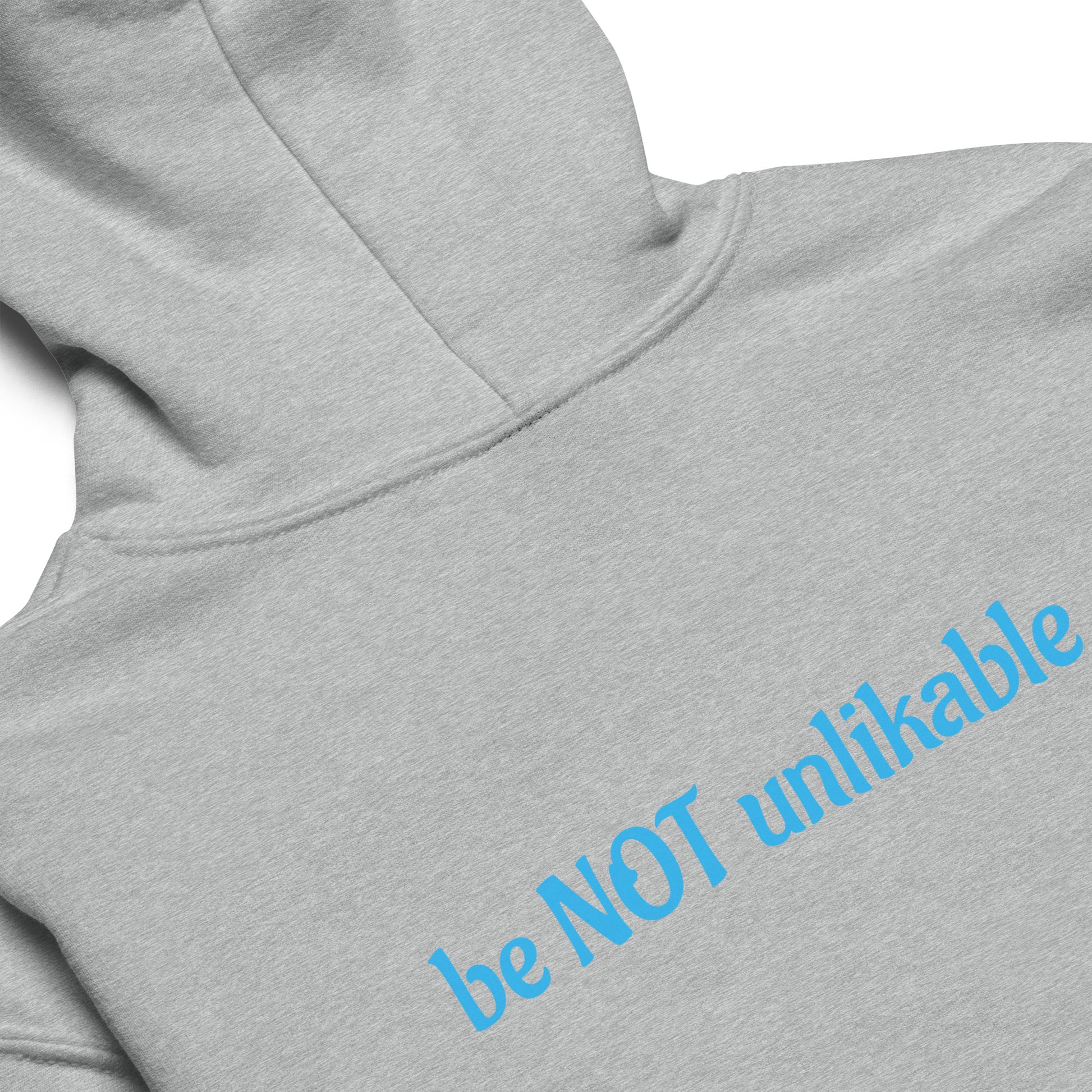 Gray hoodie with blue text 'be NOT unlikable' on a white background