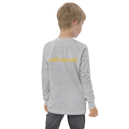 Child wearing a gray long-sleeve shirt with text on the back, standing against a white background