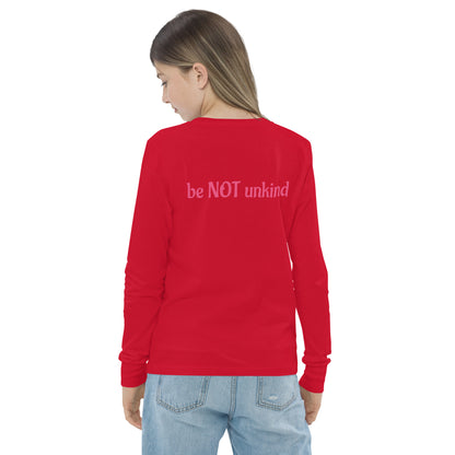 Red long-sleeve shirt with 'be NOT unkind' text on the back, worn by a person.