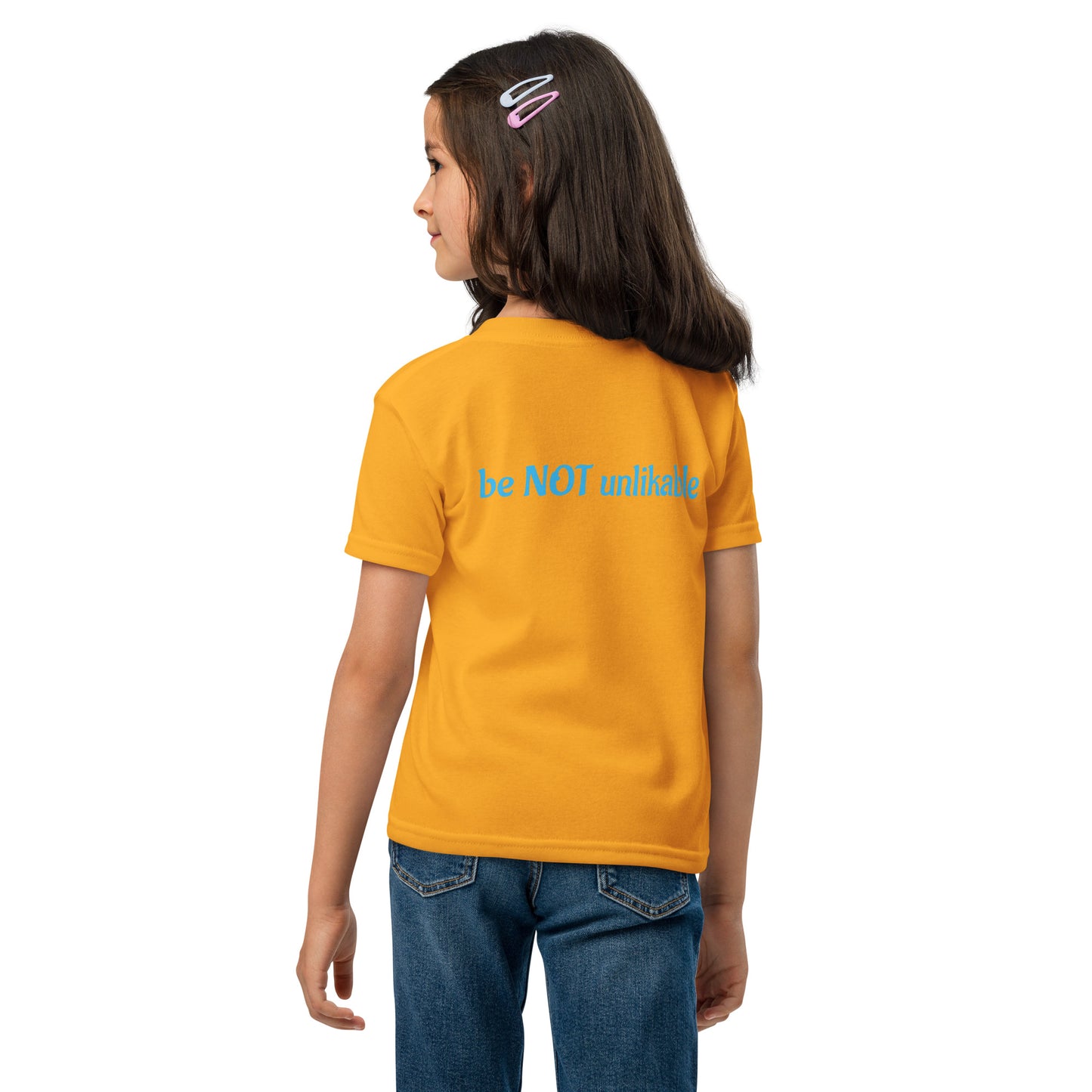 Girl wearing tshirt with 'be not unlikable' text on a white background